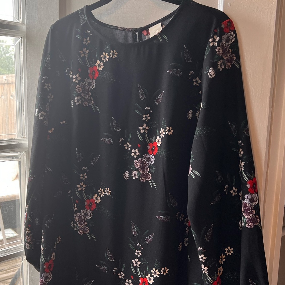 Size 12 long sleeve mid thigh dress with keyhole opening at the back.